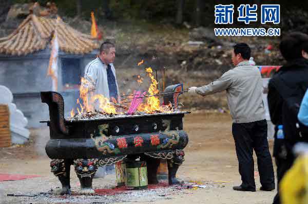 香炉山风景区的工作人员需要不停清理香炉以备下批游客继续进香。新华社记者 王松 摄